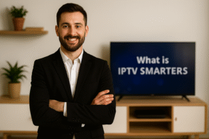 Een professionele man in pak staat glimlachend voor een tv-scherm waarop de tekst “wat is IPTV Smarters” wordt weergegeven.